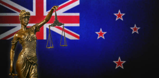 istock Lady Justice before a New Zealand flag 1032580880