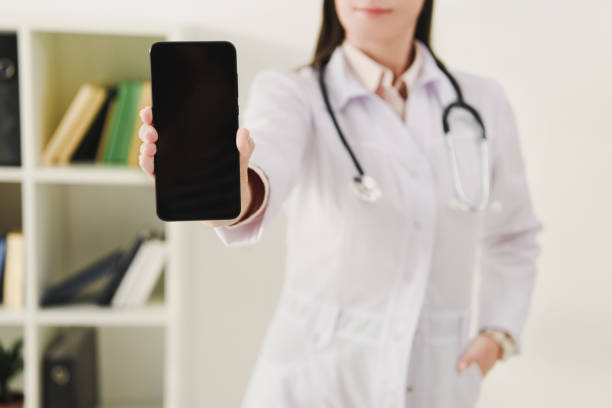 istock cropped view of doctor showing smartphone with blank screen 1032581086