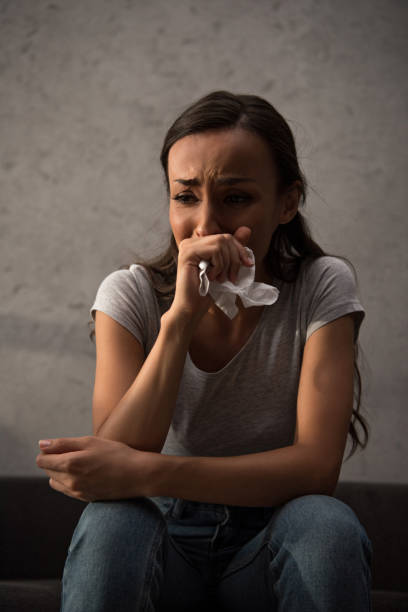 istock depressed crying woman holding napkin 1032581240