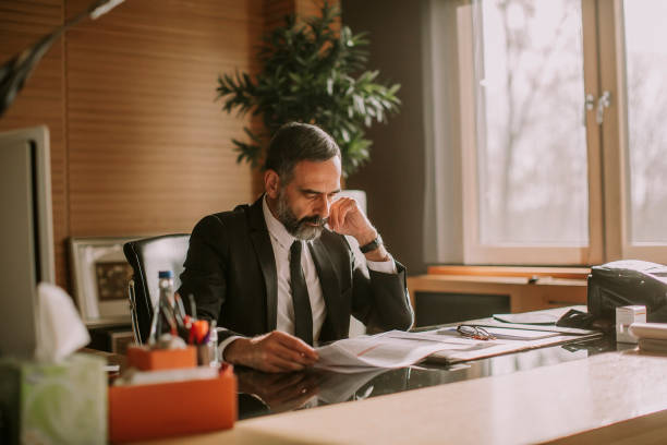 istock Senior businessman working in modern office 1032581848