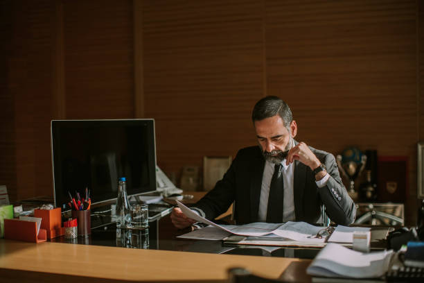 istock Senior businessman working in modern office 1032581874