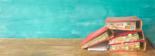 istock Messy file folders and grungy documents, red tape, bureaucracy concept 1032587156