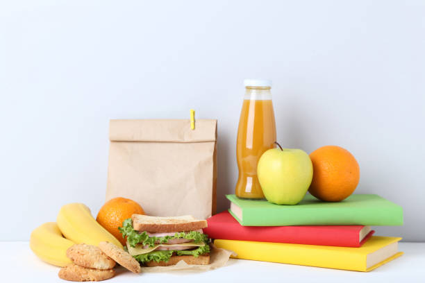 istock School lunch with paper bag and books on grey background 1032592022