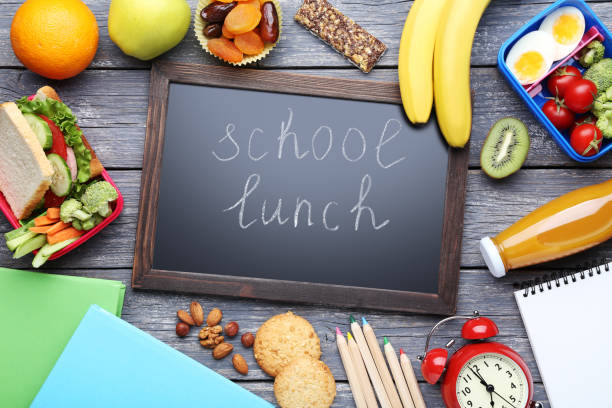 istock School lunch and black frame with inscription on wooden table 1032594250