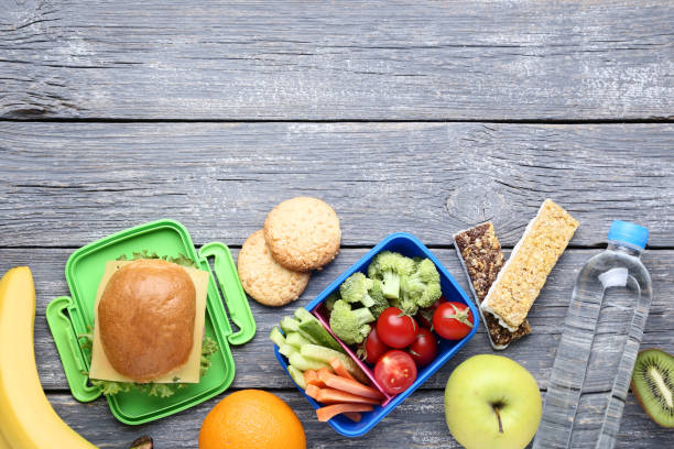 istock School lunch box with sandwich and vegetables on wooden table 1032594652