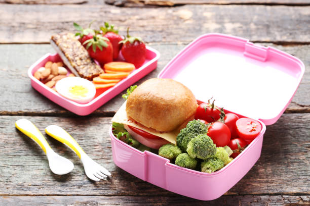 istock School lunch box with sandwich and vegetables on wooden table 1032595130