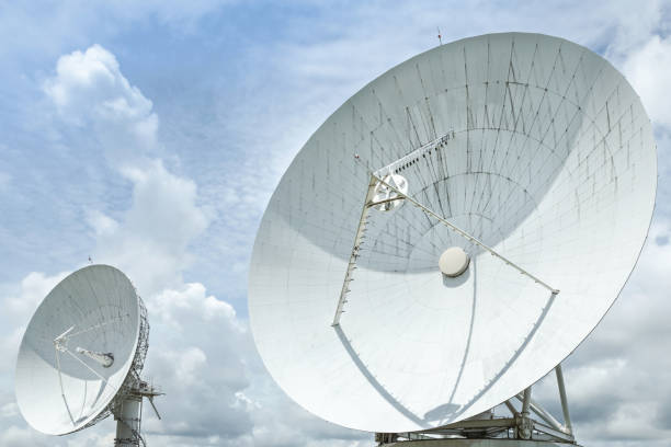 istock large white satellite dishes turn up skyward on blue sky 1032600622