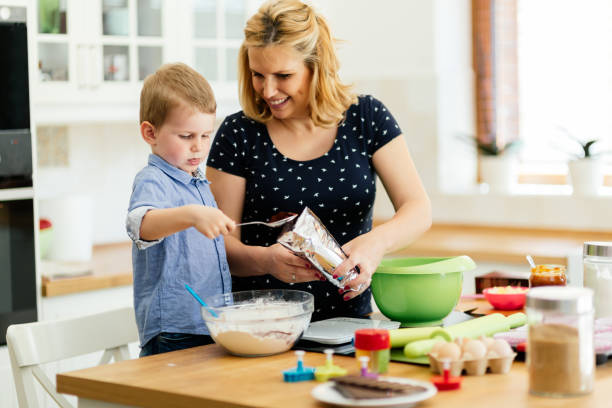 istock Child helping mother make cookies 1032604532