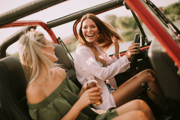 istock Attractive young women in a convertible car 1032604968