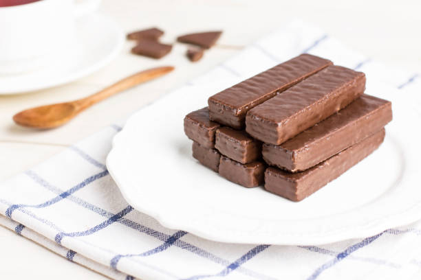 Chocolate Waffle bars on a white plate with cup of tea