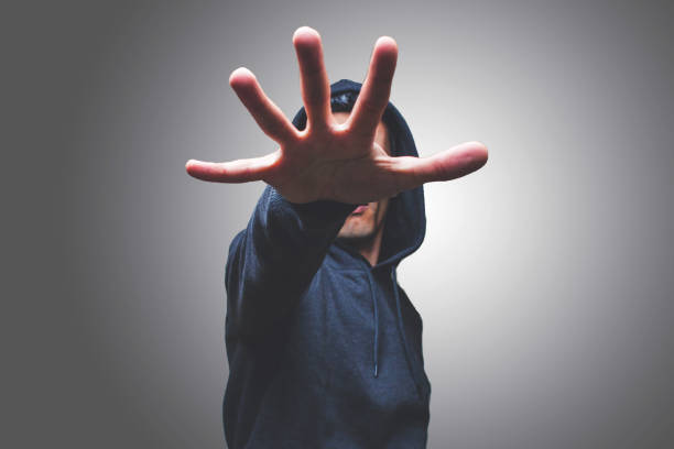 istock Mid Adult Man Gesturing While Standing Against Gray Background 1032609318
