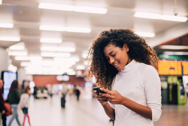 istock Gorgeous girl with curly hair using phone. Close-up. 1032613084