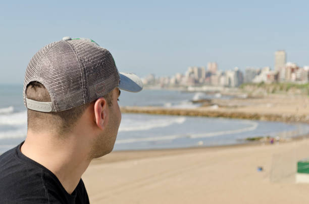 istock young man walking on the beach on a sunny day 1032614420