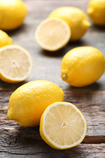 istock Ripe lemons on grey wooden table 1032617560