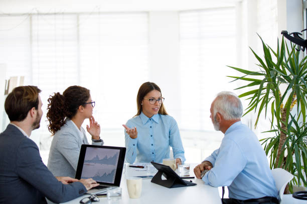 istock Business people having board meeting in modern office 1032617684