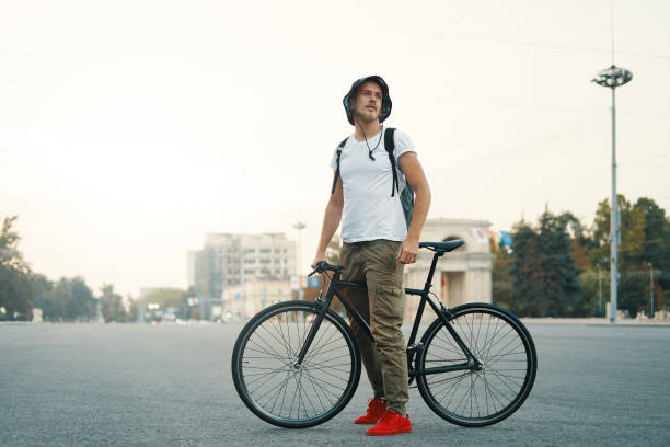 istock Portrait of young man walking with thoughtfully classic bicycle 1032618414