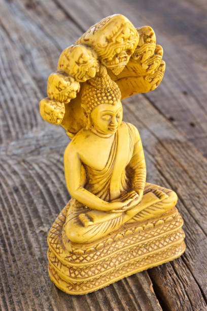 istock Buddha statue on wooden background 1032627520