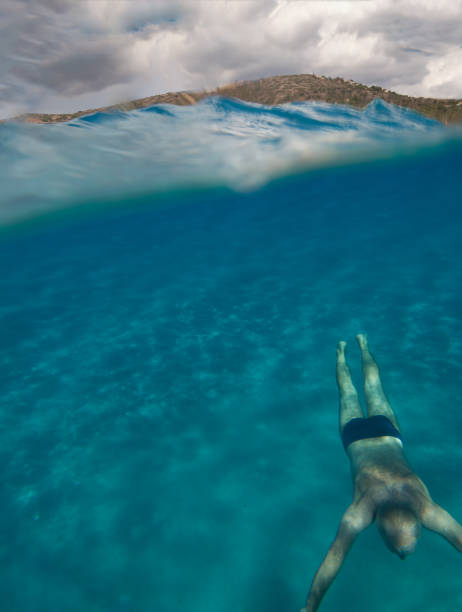 istock senior man floating underwater on the blue ocean -health and activity concept 1032627982