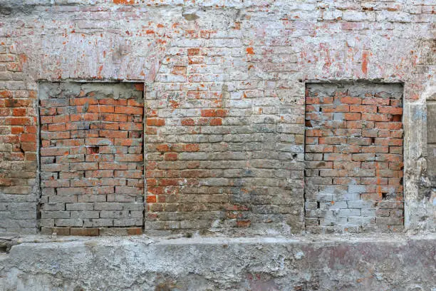 Brick wall of old house with bricked-up windows. Abstract brick wall texture