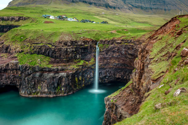 istock Scenic View Of Waterfall On Mountain 1032628562