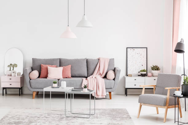 istock Patterned wooden armchair in tables and grey couch in white flat interior with poster. Real photo 1032629428