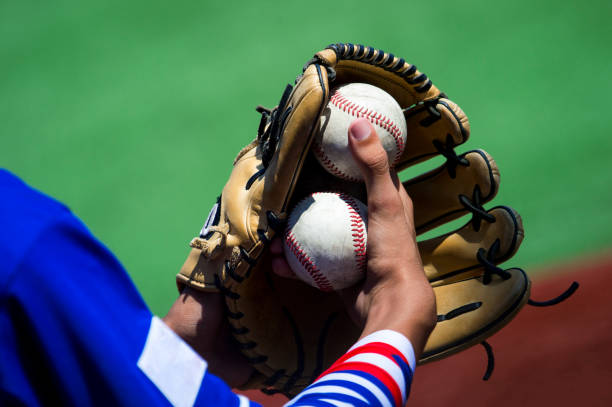 istock Midsection Of Baseball Player Holding Glove And Balls 1032631698