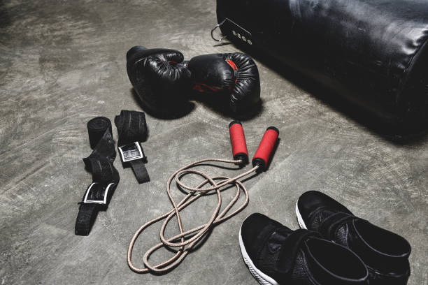 various boxing equipment lying on concrete surface various boxing equipment lying on concrete surface boxing shoes stock pictures, royalty-free photos & images