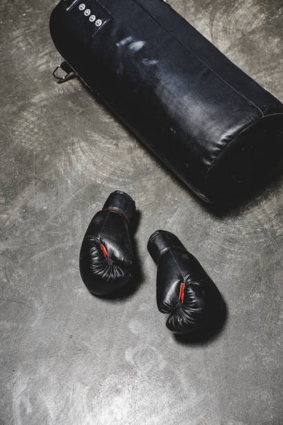 istock punching bag and boxing gloves on concrete surface 1032632674