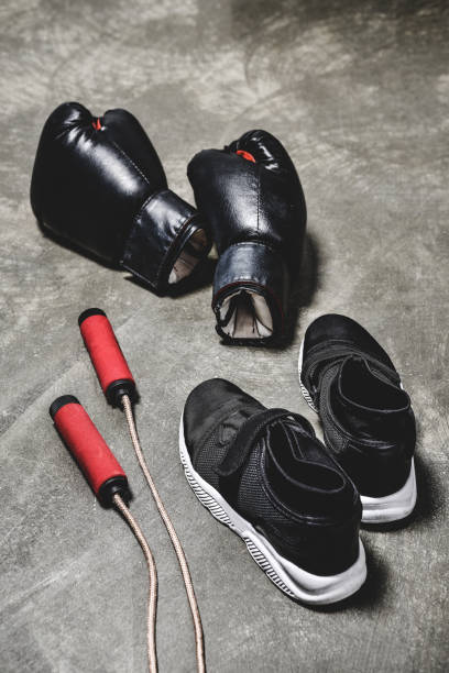 istock sneakers with jumping rope and boxing gloves on concrete surface 1032632684