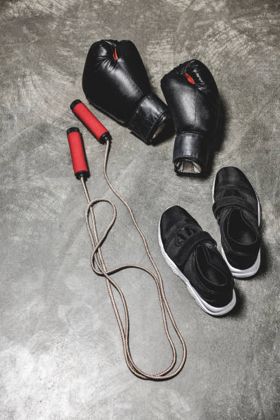 istock sporting shoes with jumping rope and boxing gloves on concrete surface 1032632686