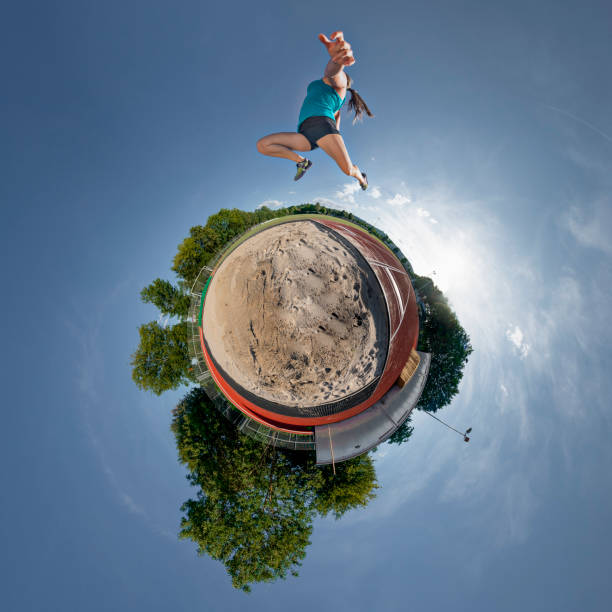 little planet of long jump of a young woman panorama little planet of long jump of a young woman heptathlon stock pictures, royalty-free photos & images