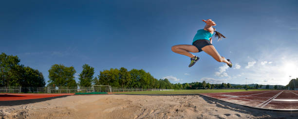 panorama of long jump of a young woman 180 degree of panorama of long jump of a young woman heptathlon stock pictures, royalty-free photos & images