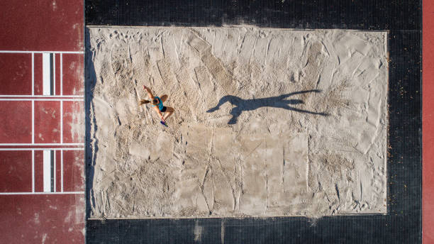 aerial shot of long jump aerial shot of long jump of a young woman heptathlon stock pictures, royalty-free photos & images