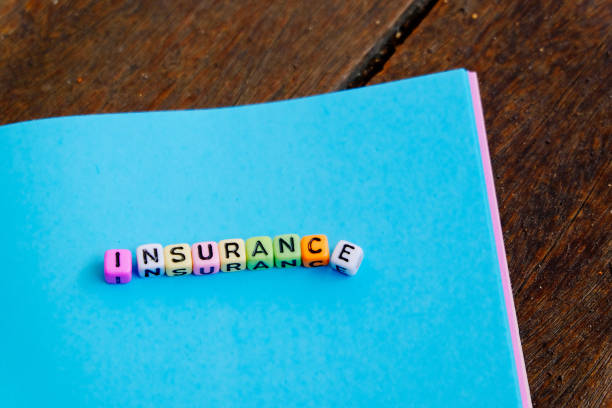 istock conceptual image with INSURANCE word block on note pad over soft focus bakground 1032644558