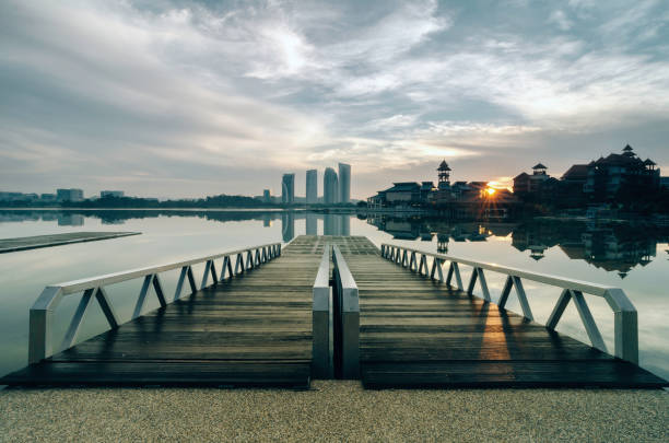 istock modern building and wooden jetty. dramatic clouds and sunlight 1032645362