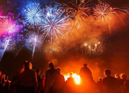 People standing in front of colorful Firework