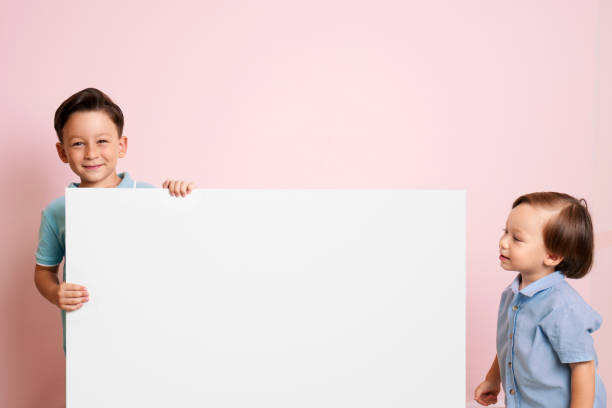 istock Cute child is holding white poster. 1032651086