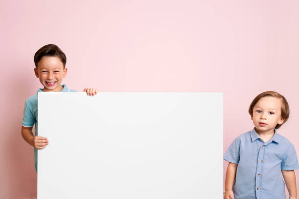 istock Cute child is holding white poster. 1032651164