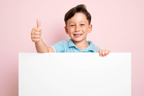 istock Cute child is holding white poster. 1032651708