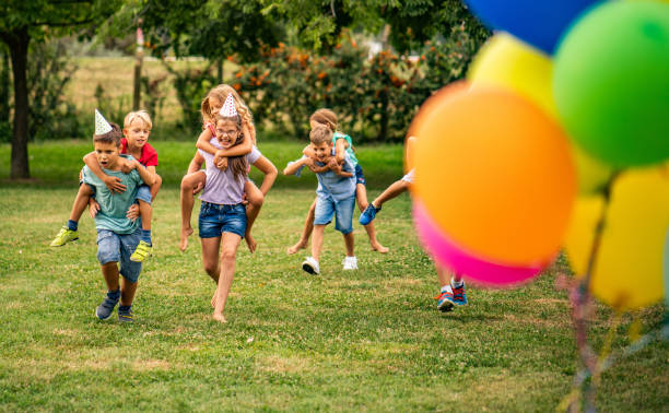 istock birthday outside at the park, kids running 1032653922