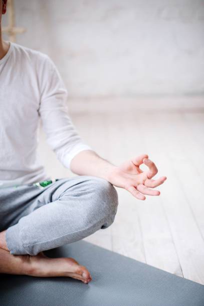 istock Low Section Of Man Doing Yoga In Studio 1032654158