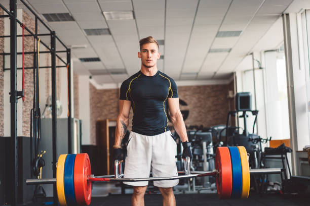 istock Muscular man working out alone at local gym 1032656346