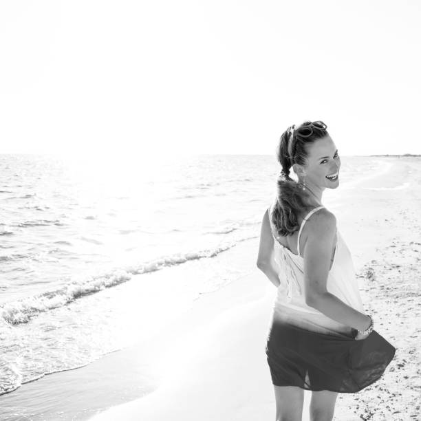 istock happy modern woman on seashore in evening walking 1032681602