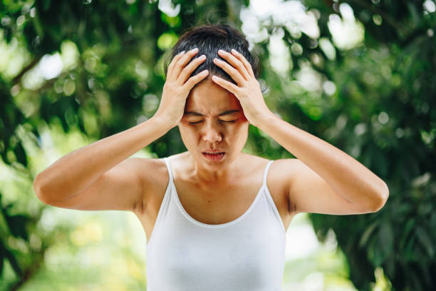 istock Young woman feeling stressed on nature green background 1032681682