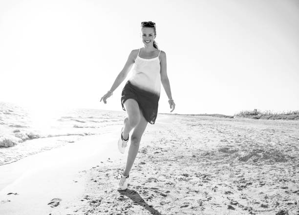 istock happy modern woman on seacoast in evening having fun time 1032681716