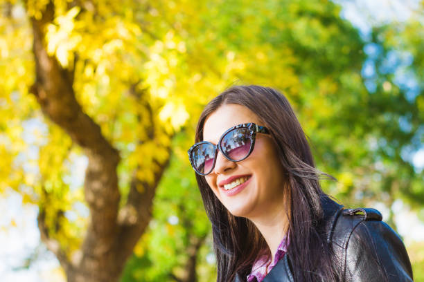 istock Beautiful young woman in autumn park. 1032682040