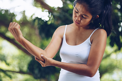 Woman with pain in shoulder and upper arm , Health Care Concept