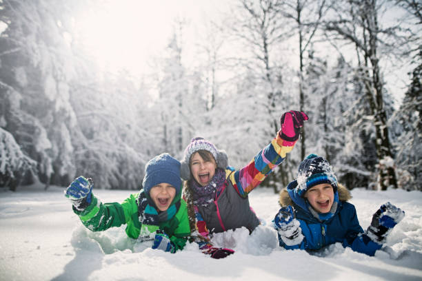 istock Happy kids playing in beautiful winter forest 1032682596
