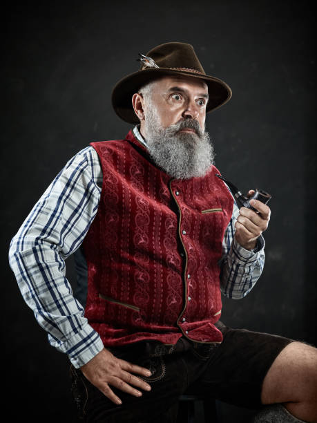 istock dramatic portrait of senior smoking tobacco pipe 1032683314