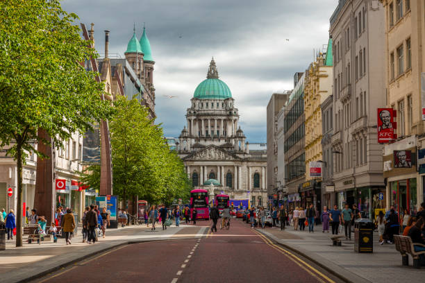 Belfast, Northern Ireland-U.K - July 30, 2018: View along a street to the City Hall in Belfast. Many tourists are around.